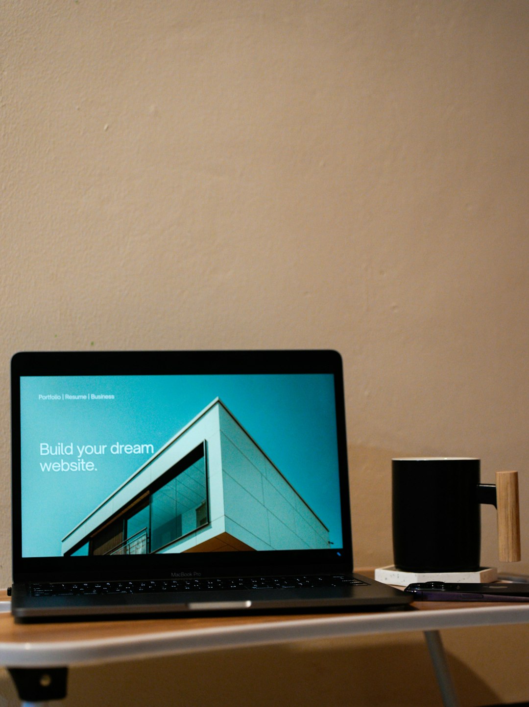 journey A laptop on top of a table with a coffee mug beside. Build your dream website for your future.